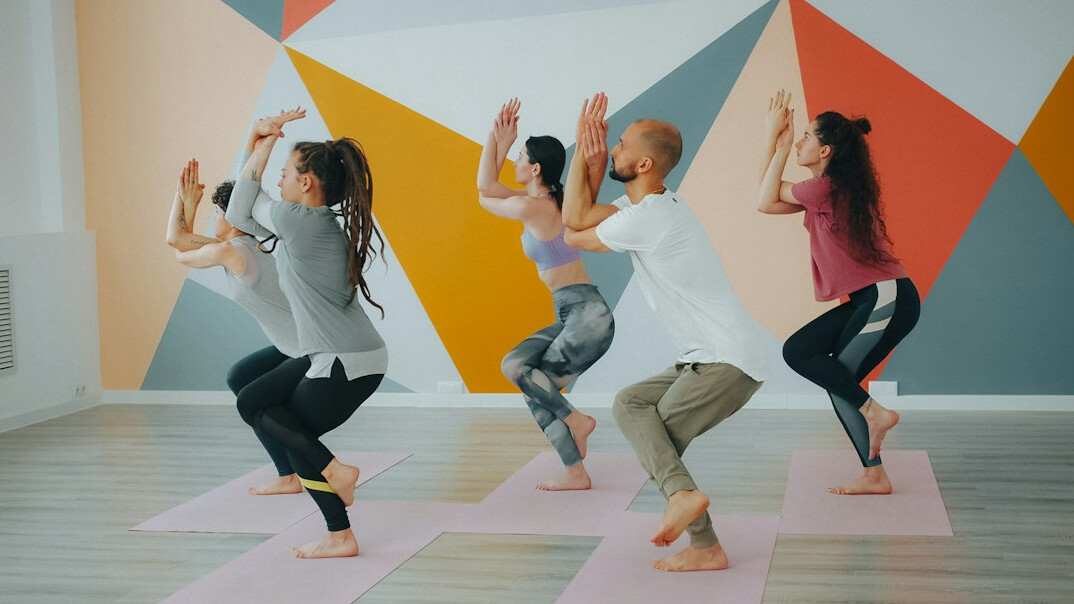 Small group fitness class exercising together indoors